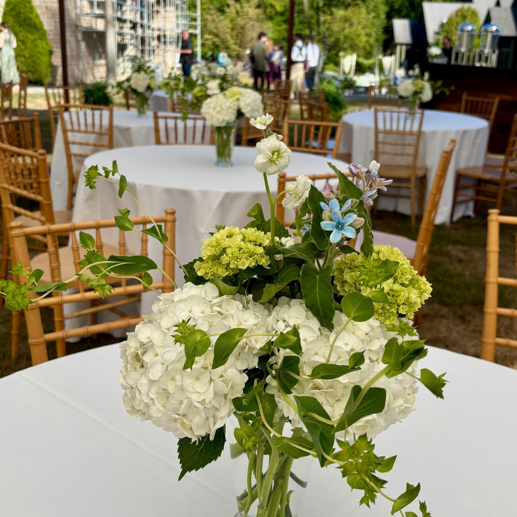 White and green flowers on a garden reception table