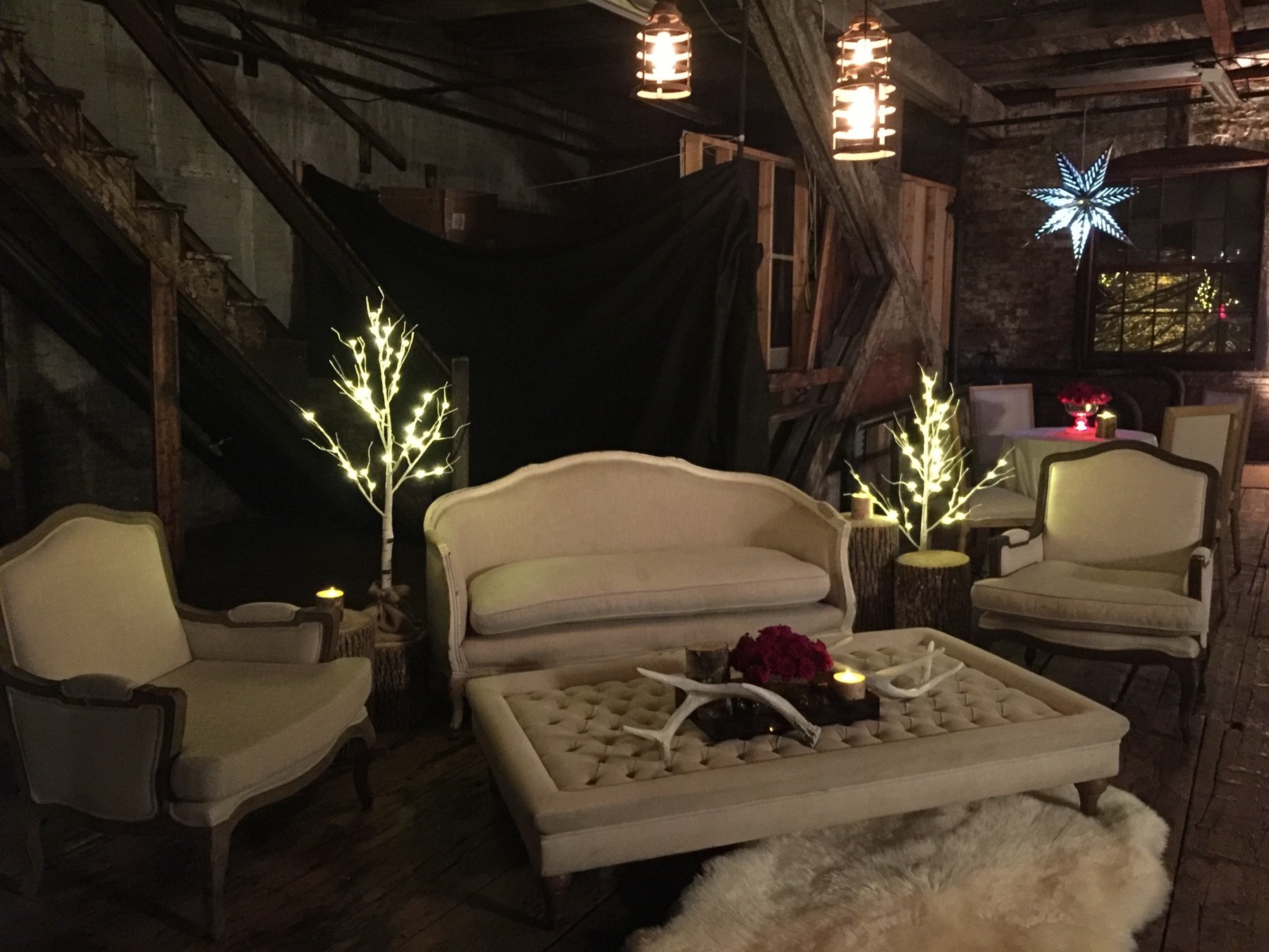 Cream upholstered seating beneath warm lights and holiday decorations
