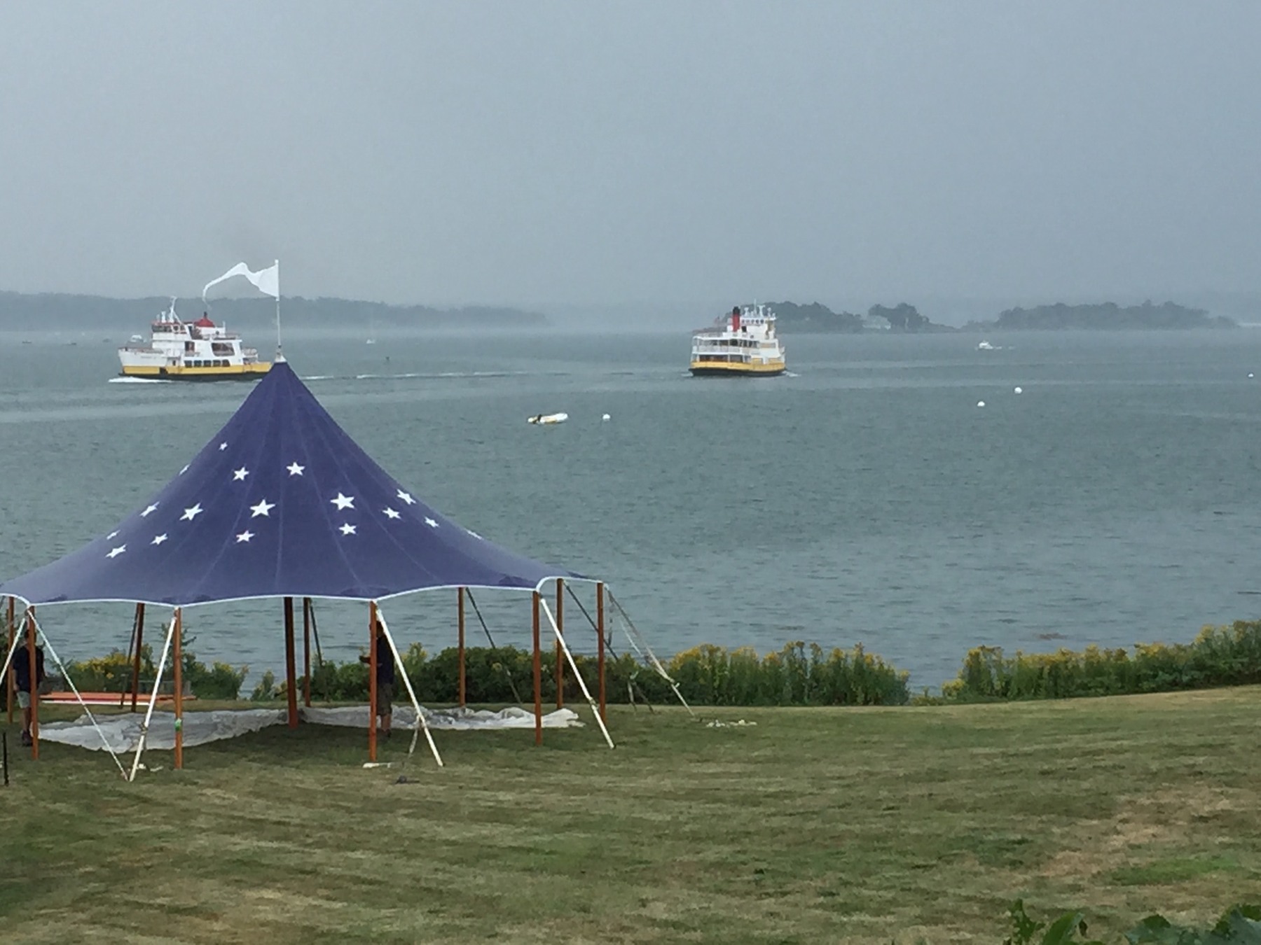 Small blue star-patterned tent beside the water