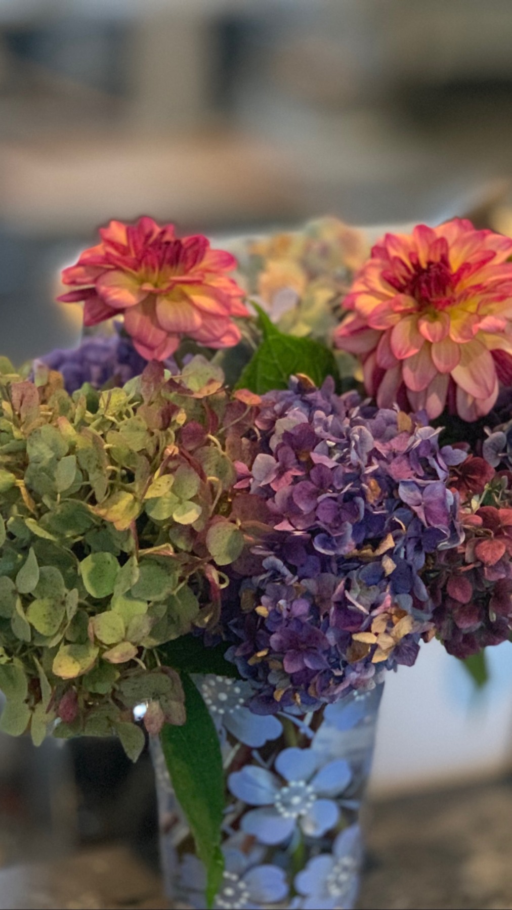 Purple and green hydrangeas with pink and orange flowers