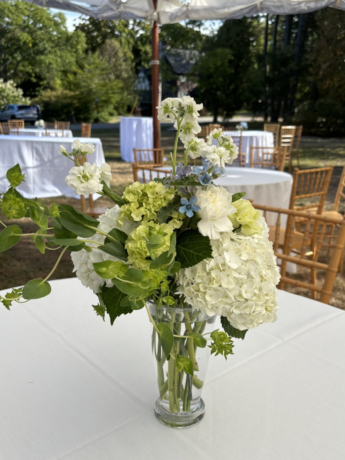 White and green flowers on a September garden reception table
